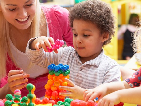 Woman playing with children in an in home daycare